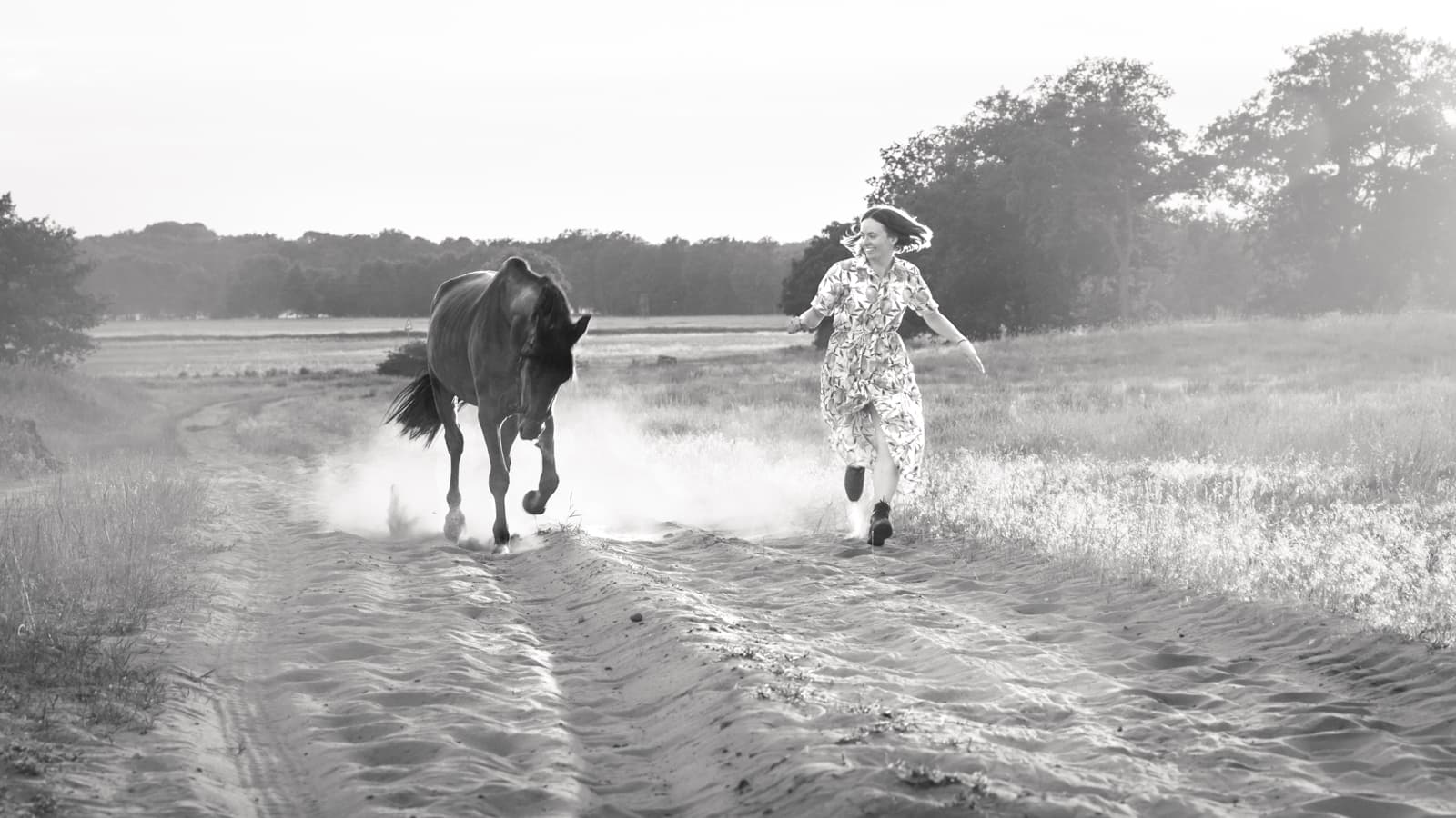 Woman running with horse in field