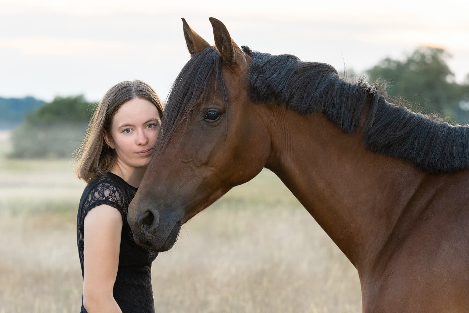 Woman running with horse in field