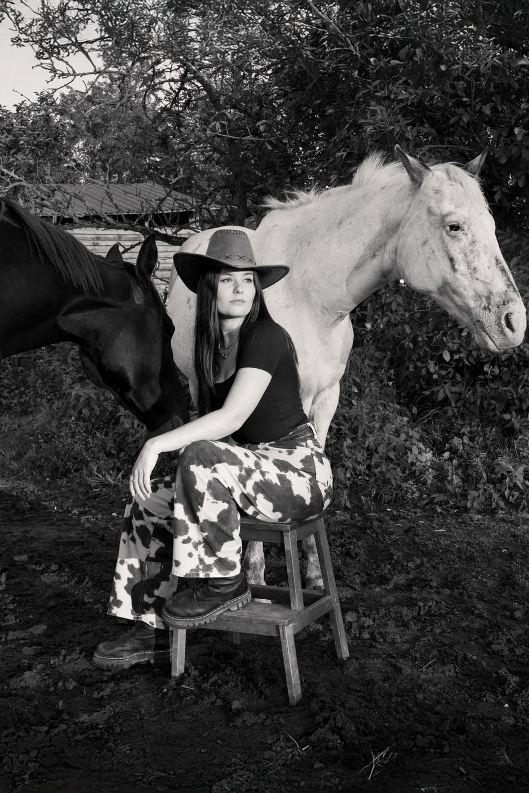 Woman with cowboy hat and two horses