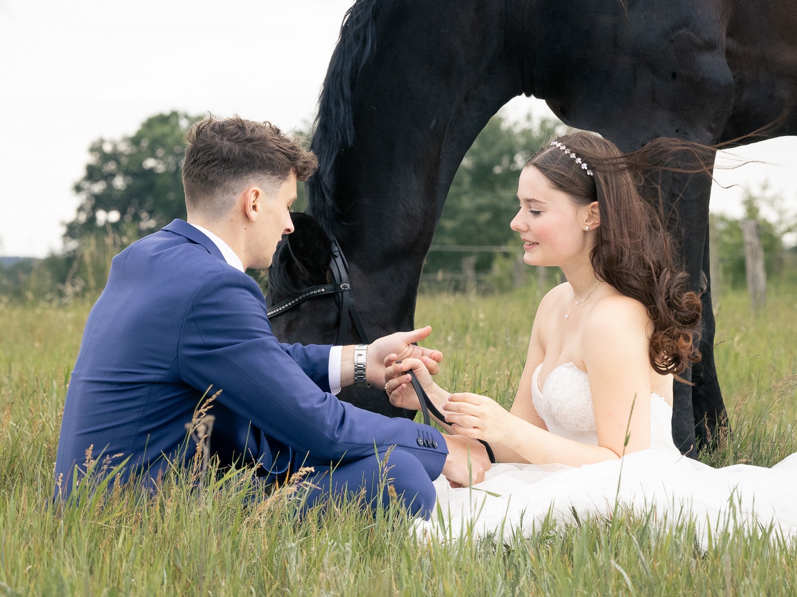 Wedding couple in intimate moment with horse in background